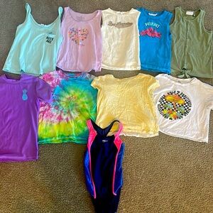 Summer pack filled with tee shirts tank tops and a bathing suit .